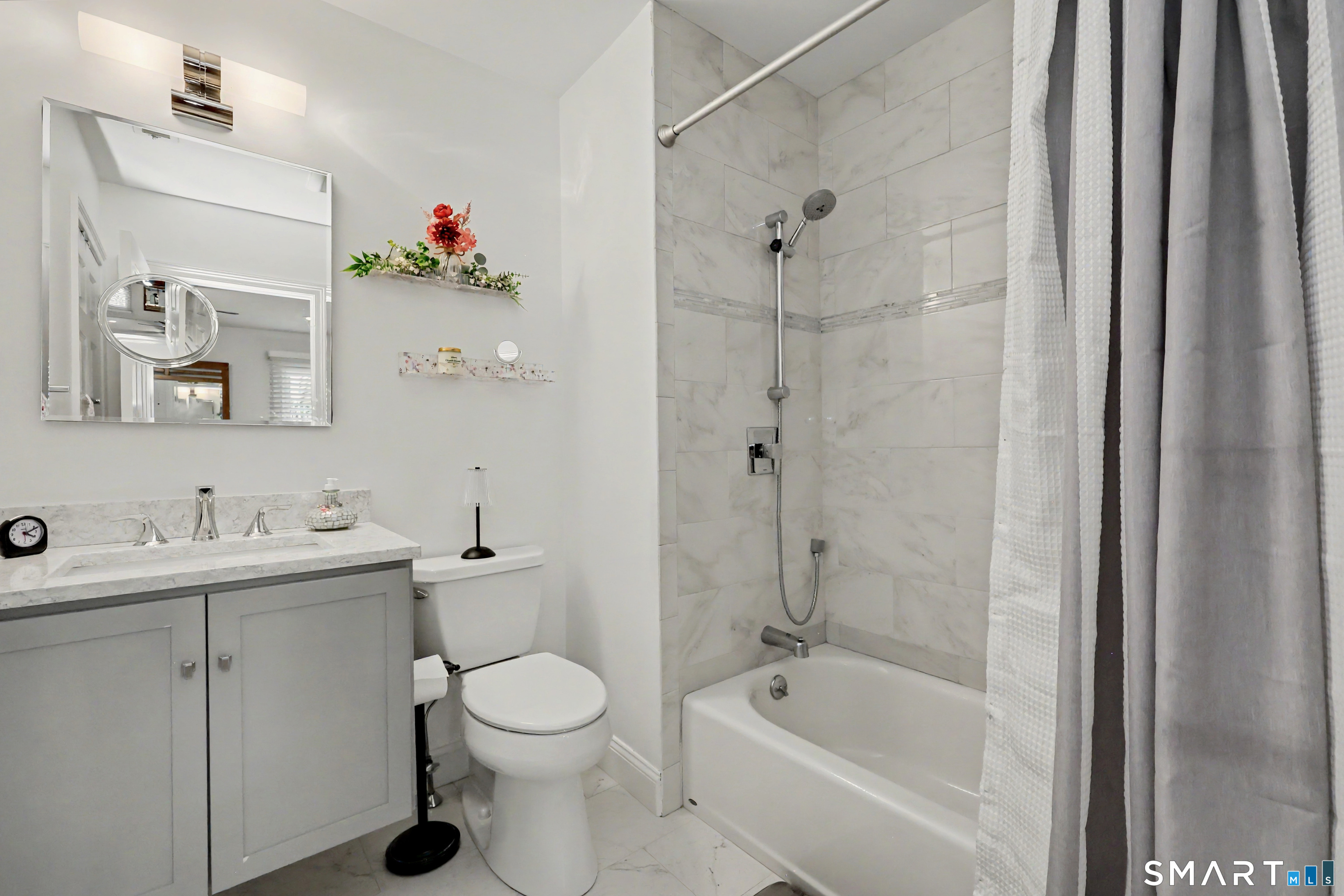 70 Fawn Ridge Lane, Unit 70 Norwalk, CT 06851 - Photo 16 of 36 a bathroom with a toilet sink vanity tub and shower