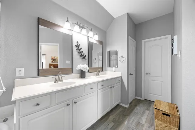 a spacious bathroom with a double vanity sink mirror and