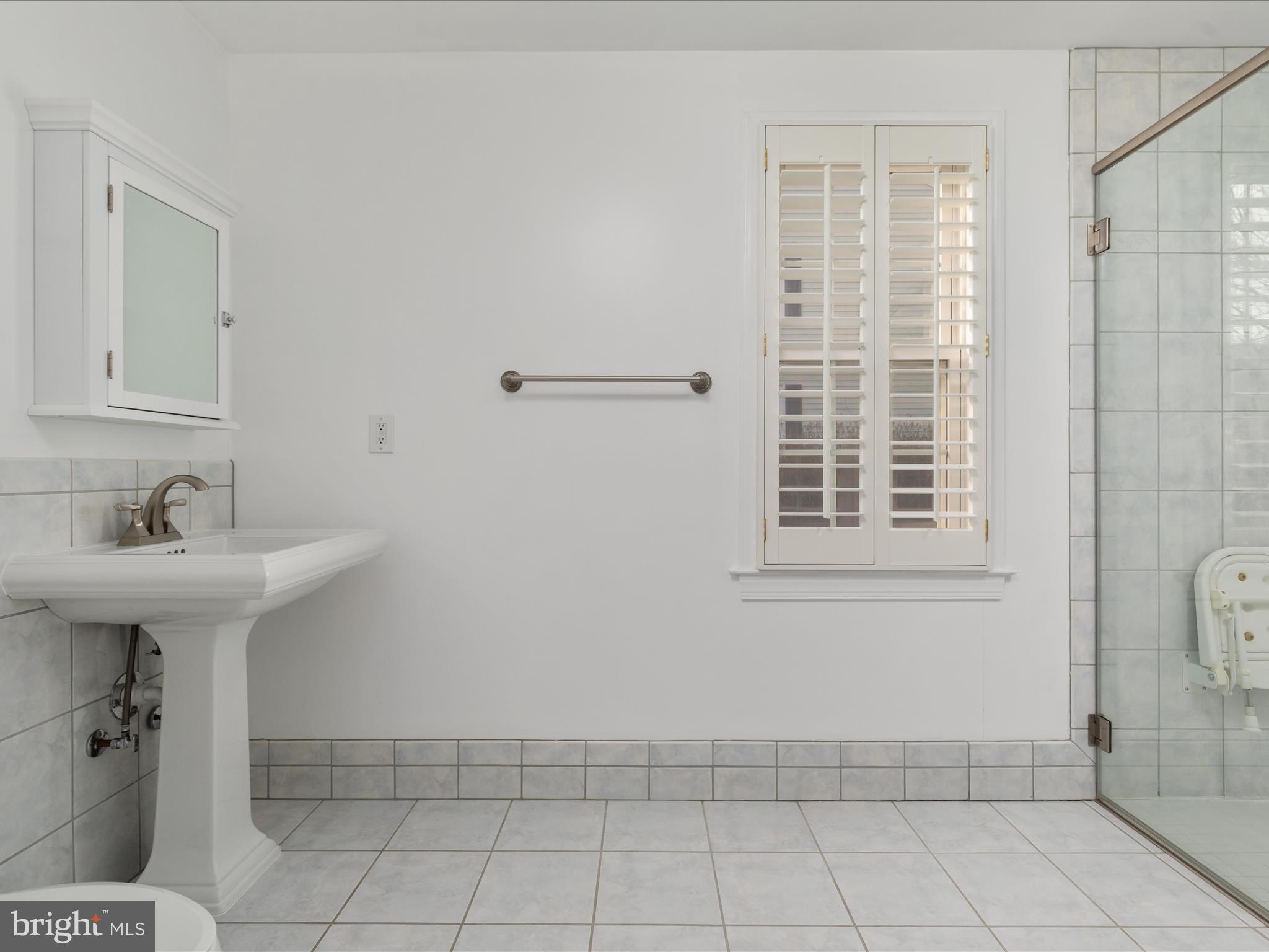 11922 Blue Spruce Road Reston, VA 20191 - Photo 12 of 65 a bathroom with a sink a toilet and shower