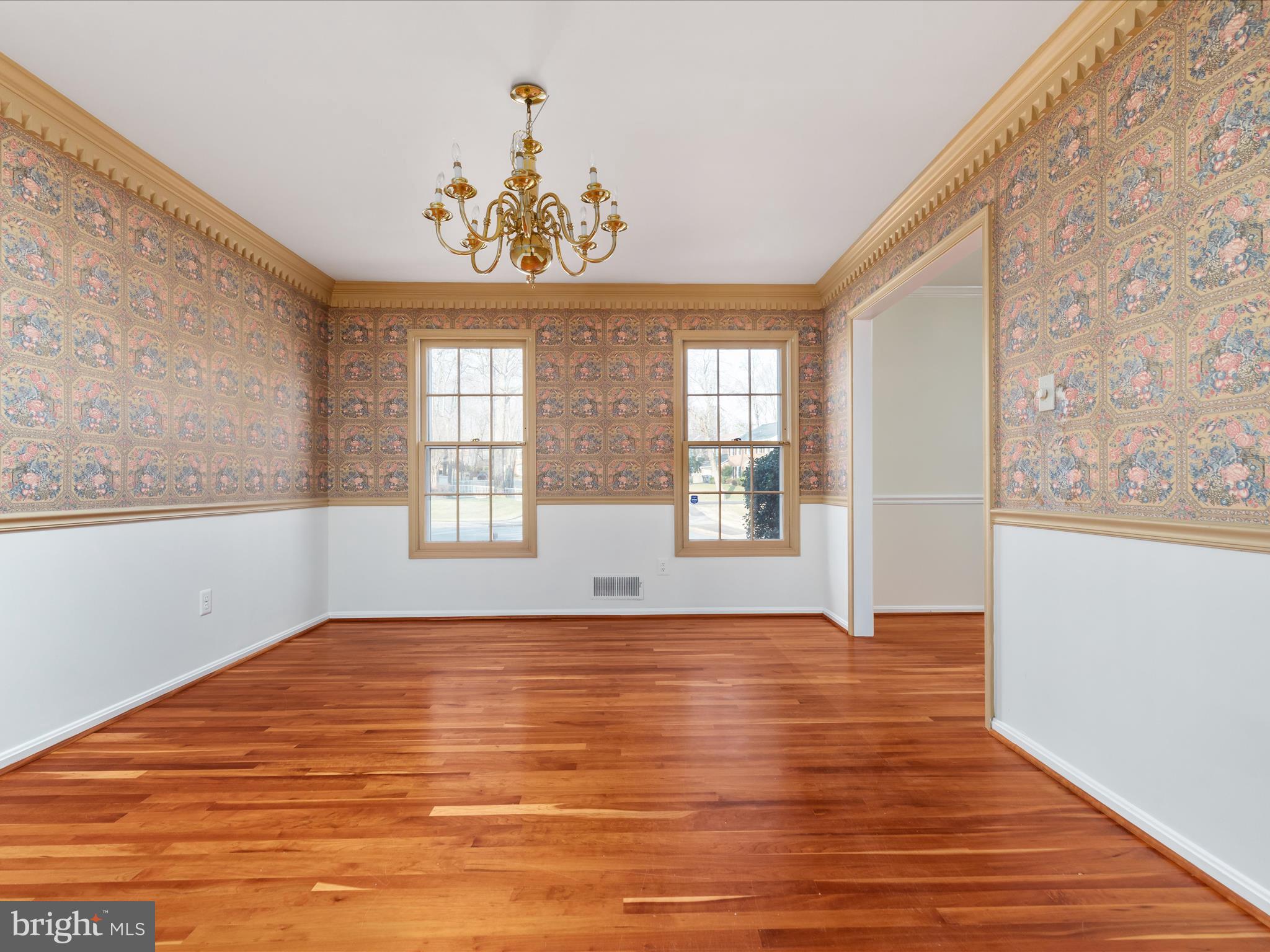 11922 Blue Spruce Road Reston, VA 20191 - Photo 16 of 65 a view of an empty room with a window and wooden floor