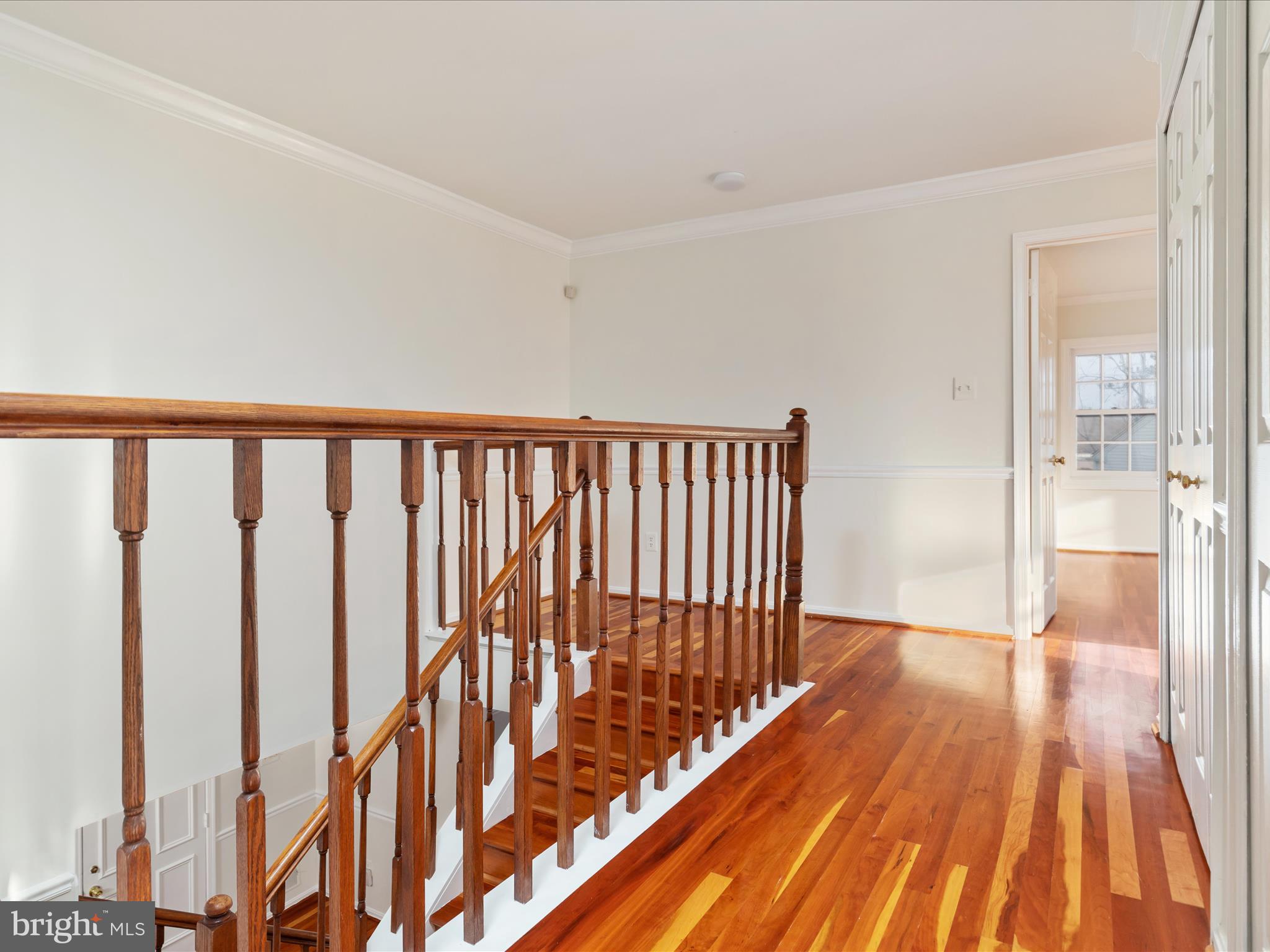 11922 Blue Spruce Road Reston, VA 20191 - Photo 18 of 65 a view of a hallway with wooden floor and staircase