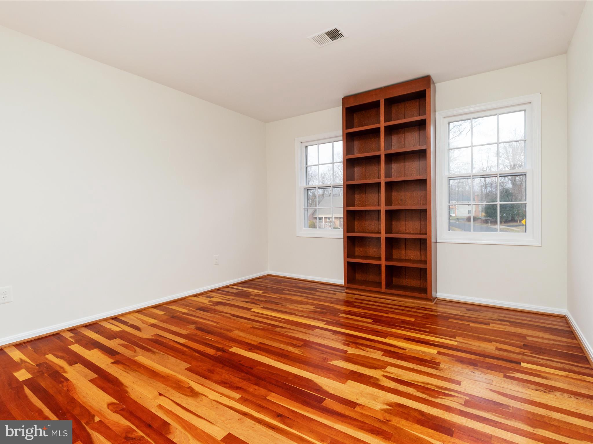 11922 Blue Spruce Road Reston, VA 20191 - Photo 19 of 65 a view of empty room with wooden floor and cabinet