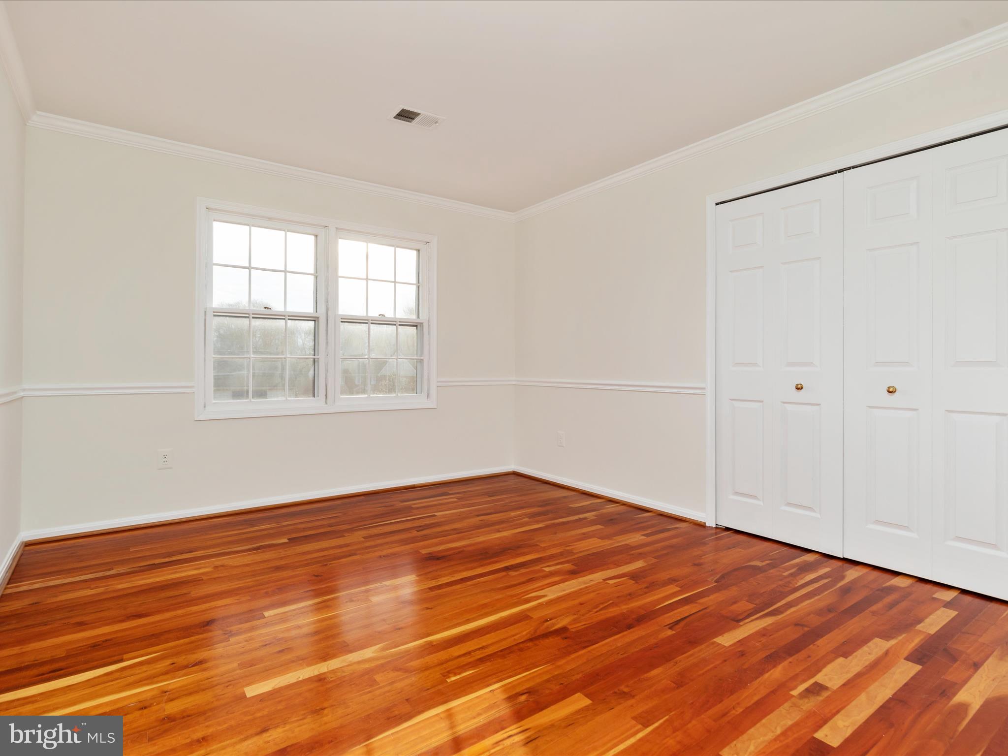 11922 Blue Spruce Road Reston, VA 20191 - Photo 21 of 65 a view of an empty room with wooden floor and a window
