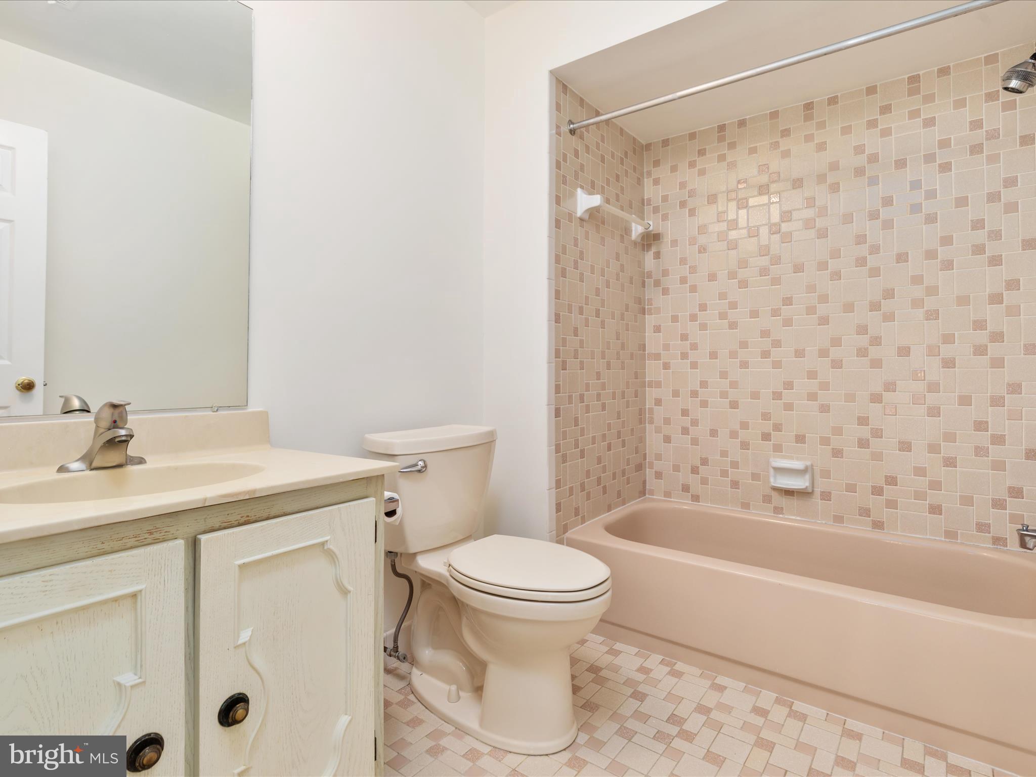 11922 Blue Spruce Road Reston, VA 20191 - Photo 22 of 65 a bathroom with a sink toilet and shower