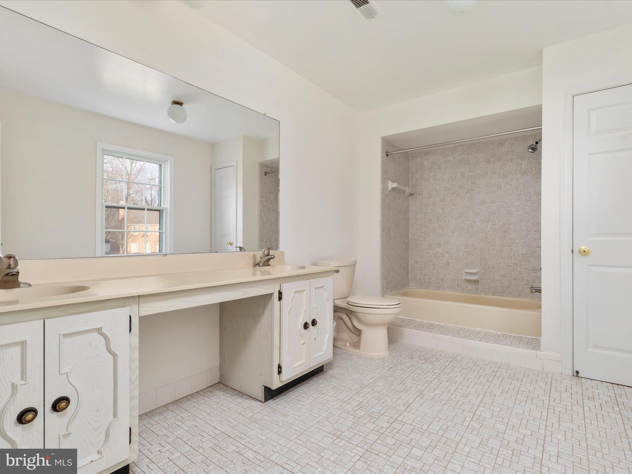 11922 Blue Spruce Road Reston, VA 20191 - Photo 28 of 65 a bathroom with a double vanity sink toilet and shower