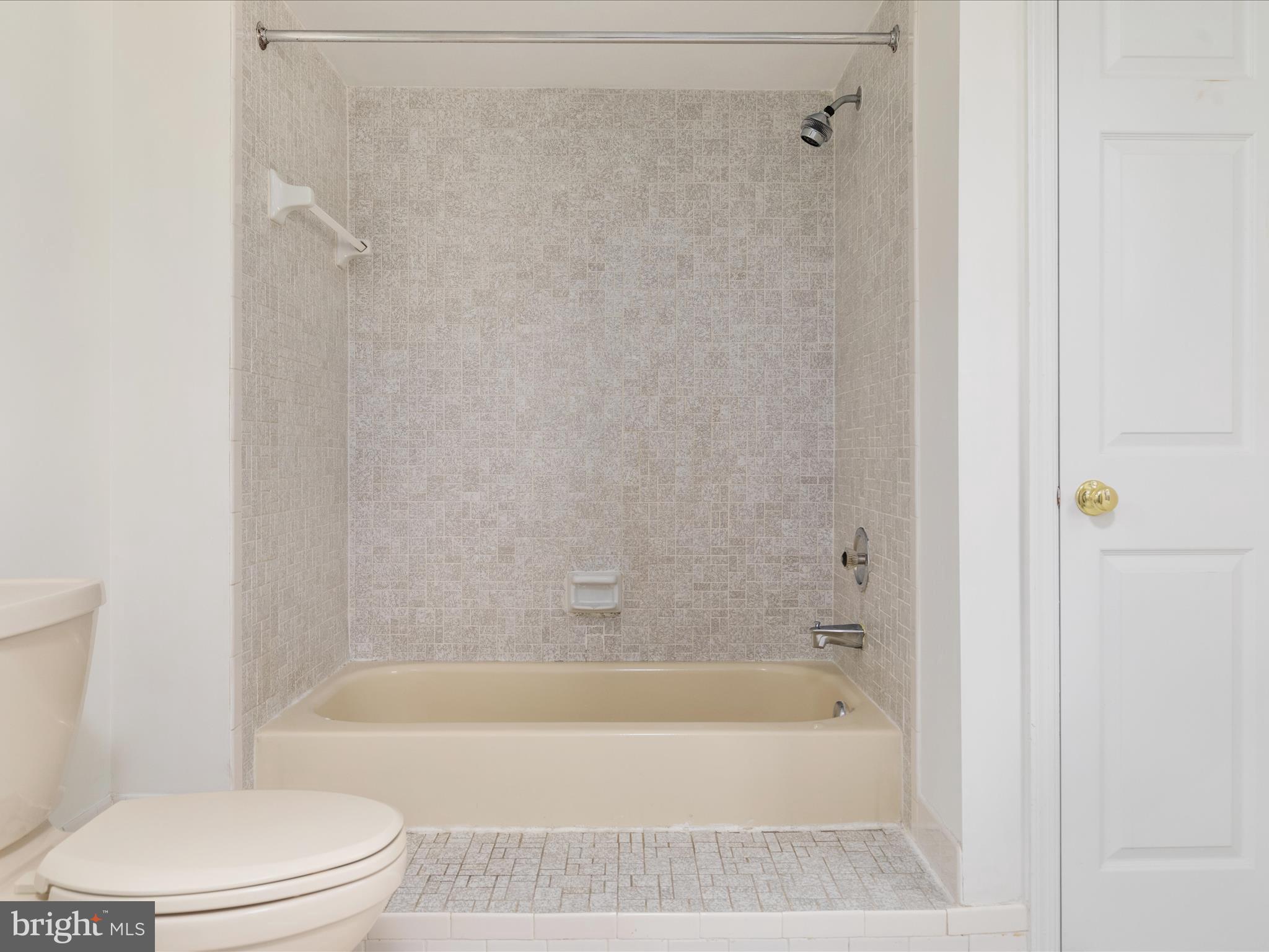 11922 Blue Spruce Road Reston, VA 20191 - Photo 29 of 65 a bathroom with a bathtub and a toilet