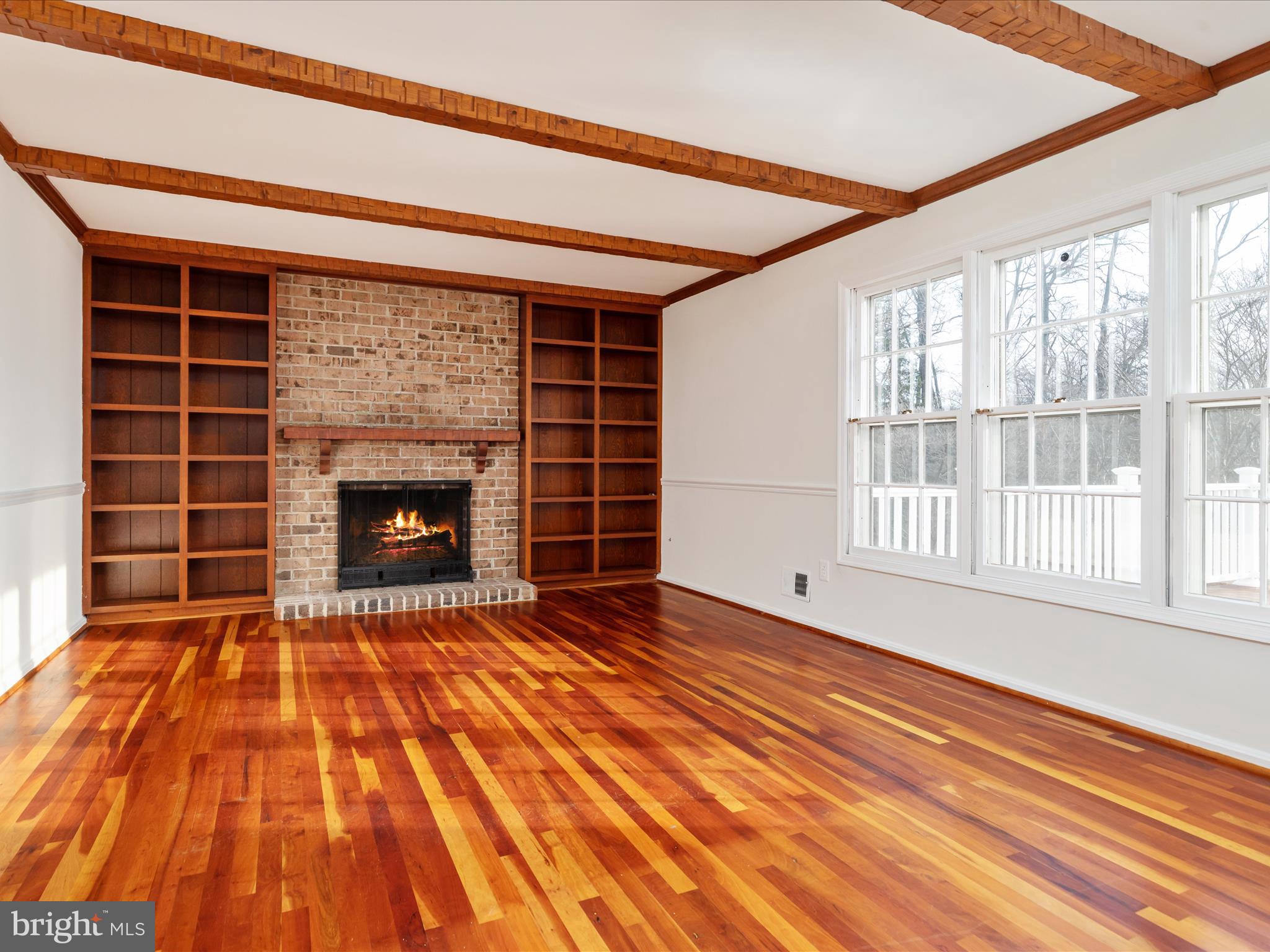 11922 Blue Spruce Road Reston, VA 20191 - Photo 3 of 65 a view of an empty room with wooden floor fireplace and a window