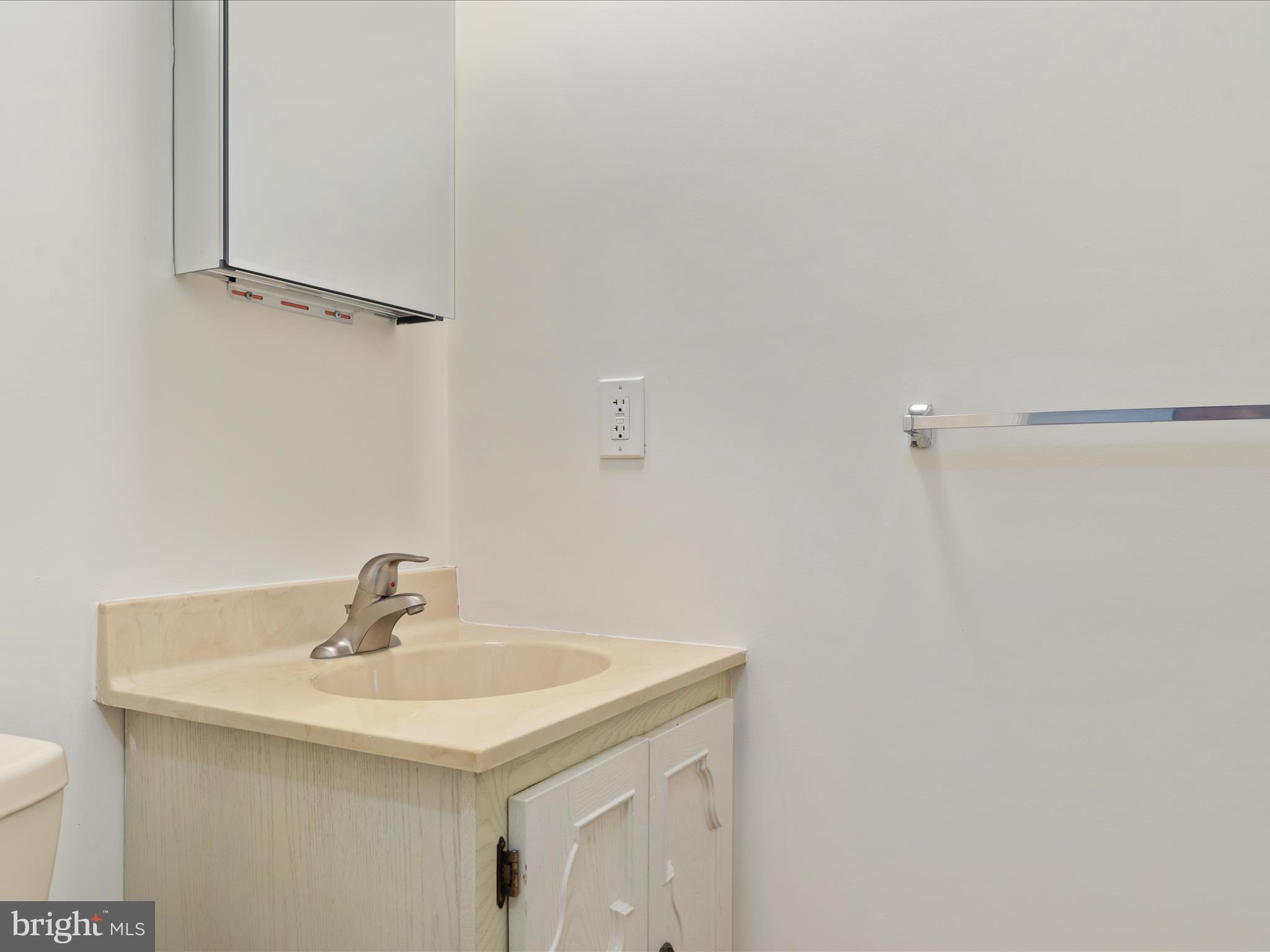 11922 Blue Spruce Road Reston, VA 20191 - Photo 34 of 65 a bathroom with a sink and mirror