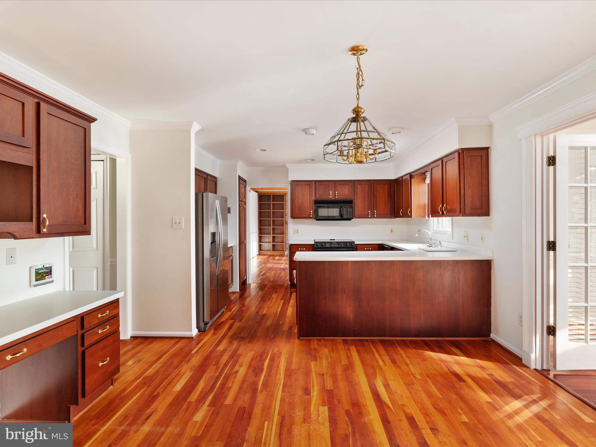 11922 Blue Spruce Road Reston, VA 20191 - Photo 5 of 65 a kitchen with stainless steel appliances granite countertop a refrigerator a stove and a wooden floors