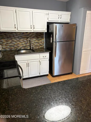 a white refrigerator freezer sitting inside of a kitchen