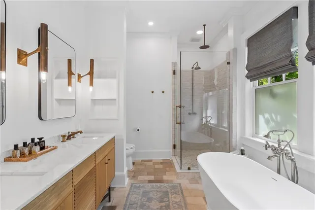 a bathroom with a tub sink and mirror