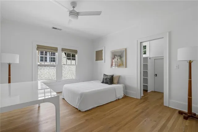 a bedroom with a bed and wooden floor