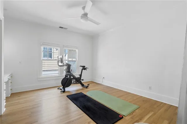 a room with gym equipment and a view of living room