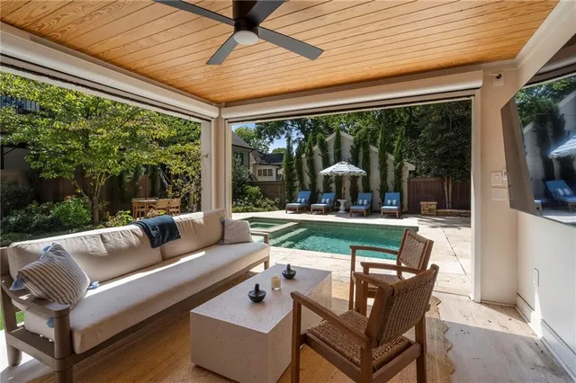 a living room with patio furniture and a floor to ceiling window
