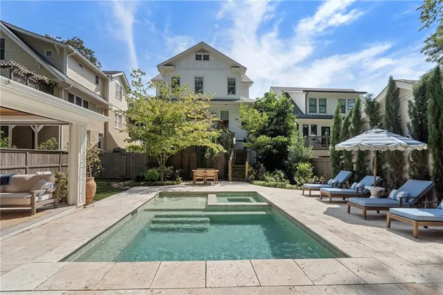 a view of a patio with a table and chairs under an umbrella
