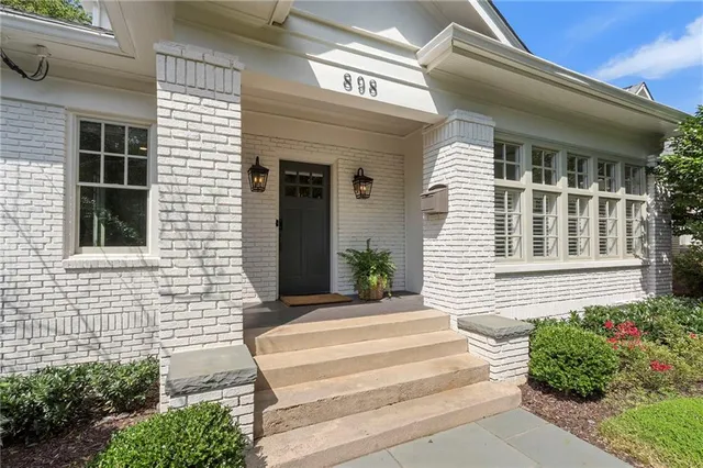 a front view of a house with a garden