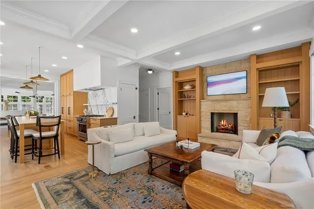 a living room with furniture fireplace and window