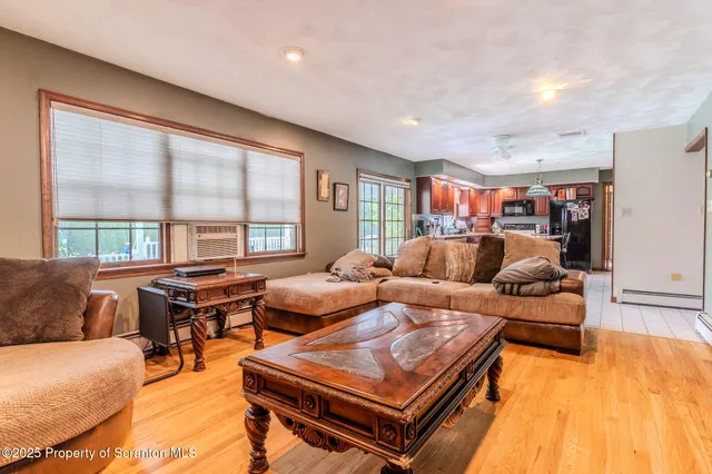 a living room with a bed furniture and a flat screen tv