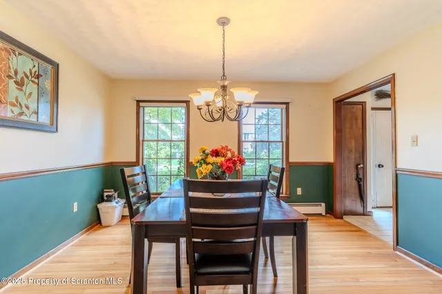 a view of a hallway with wooden floor and stairs