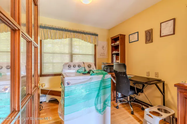 a bed sitting in a spacious bedroom next to a window