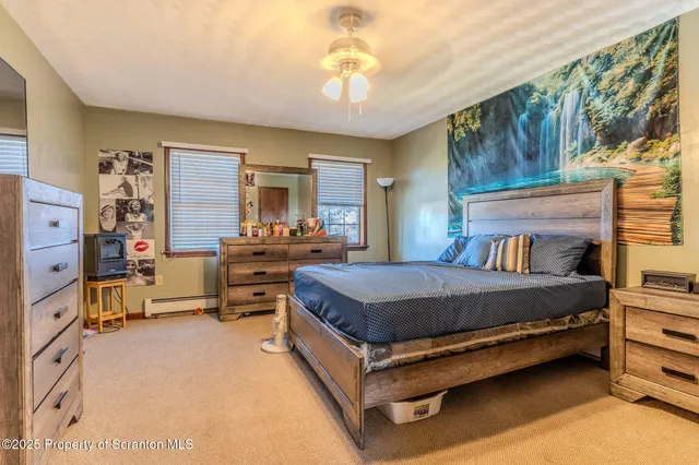 a bedroom with three beds and large windows