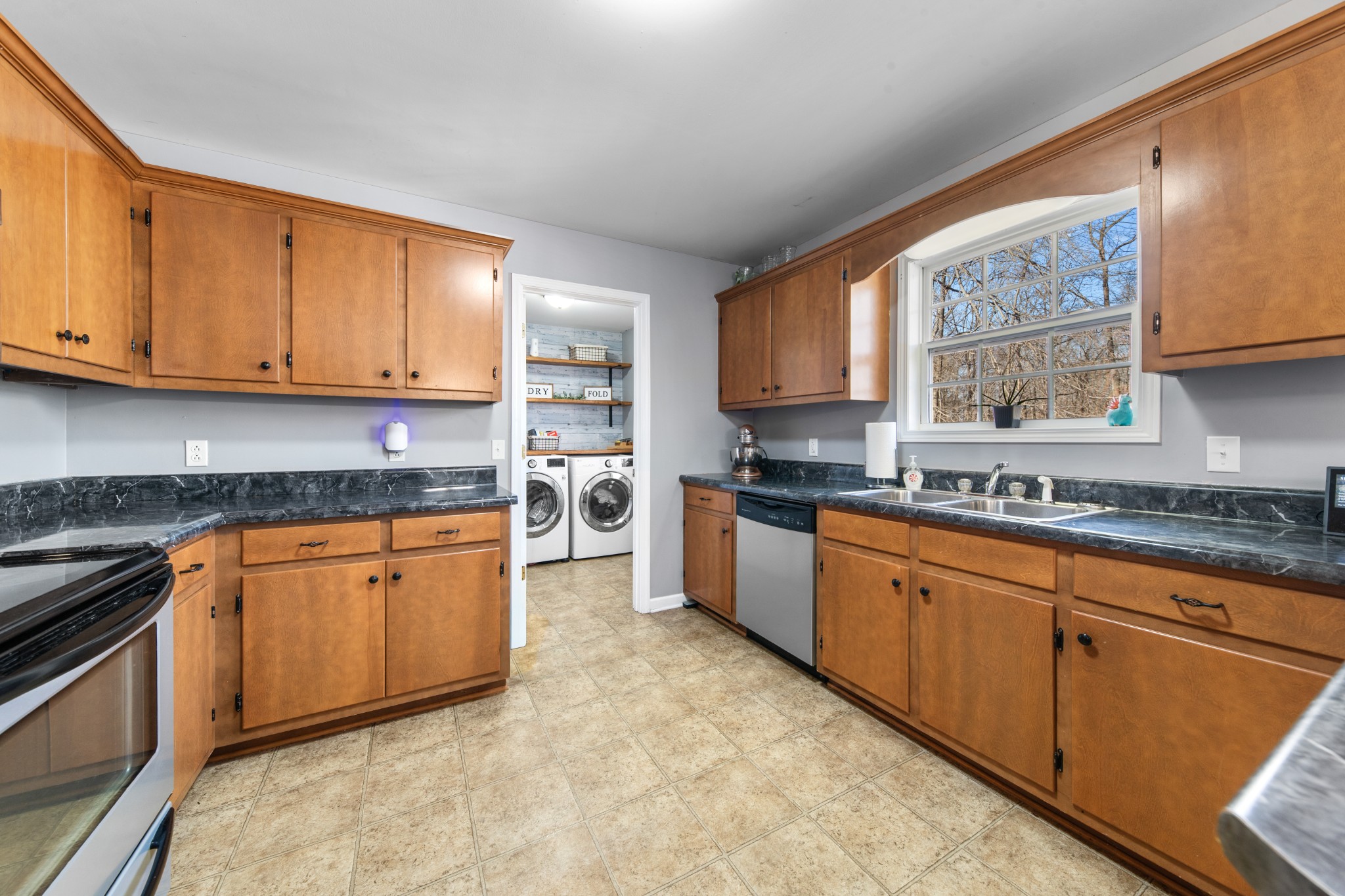129 Poling Drive Pulaski, TN 38478 - Photo 54 of 67 a kitchen with stainless steel appliances granite countertop a stove sink and cabinets