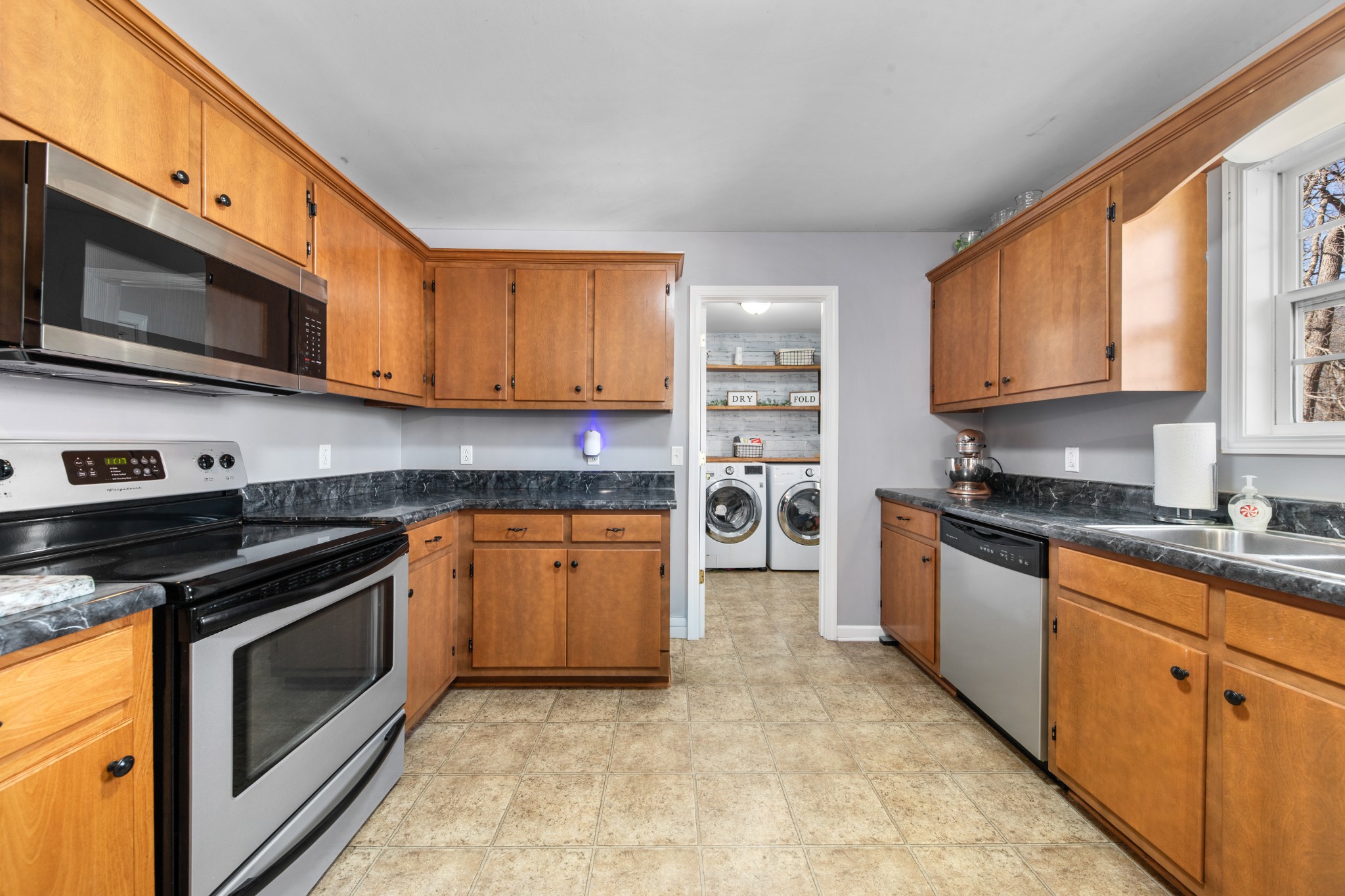 129 Poling Drive Pulaski, TN 38478 - Photo 55 of 67 a kitchen with stainless steel appliances granite countertop a stove a sink and a microwave