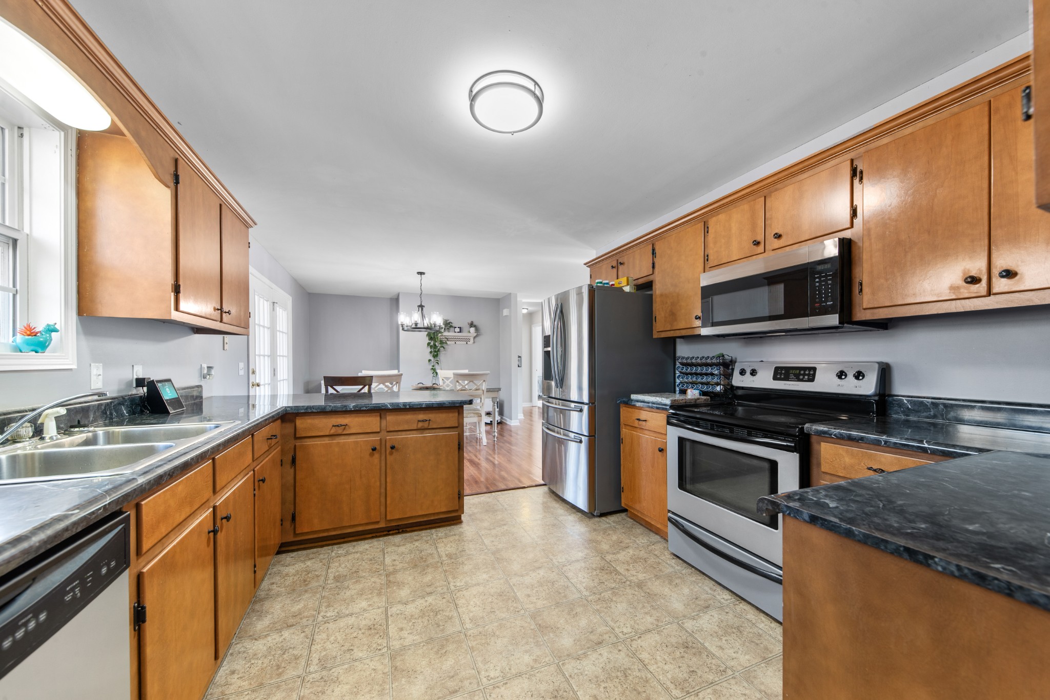 129 Poling Drive Pulaski, TN 38478 - Photo 59 of 67 a kitchen with stainless steel appliances granite countertop a stove sink microwave and refrigerator