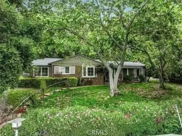 a front view of a house with yard and green space
