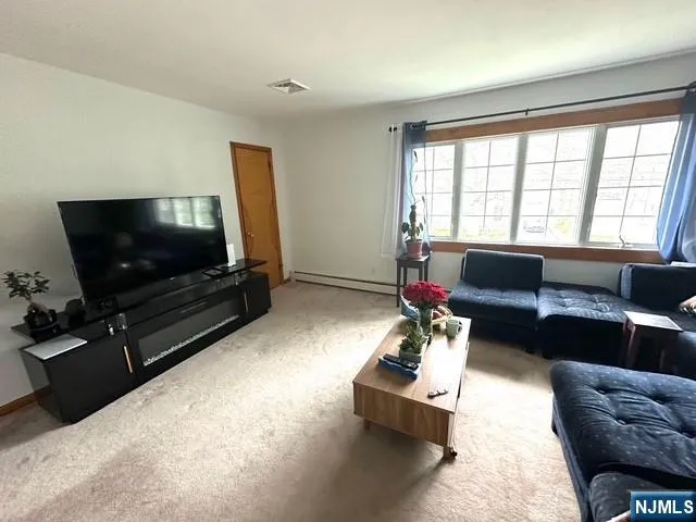 a bedroom with a bed and flat screen tv