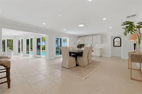 a kitchen with white cabinets and appliances