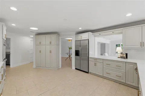 a utility room with sink dryer and washer