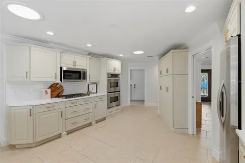 a kitchen with granite countertop a sink and cabinets