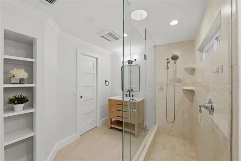 a bathroom with a shower sink and mirror