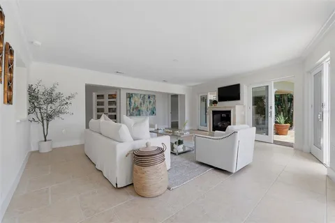 a large white kitchen with lots of counter space dining table and chairs