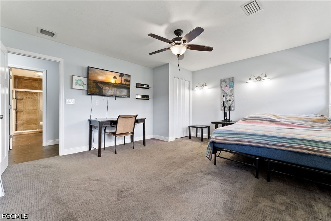 17290 Rewis Road Alva, FL 33920 - Photo 20 of 50 a bedroom with a bed and a flat screen tv