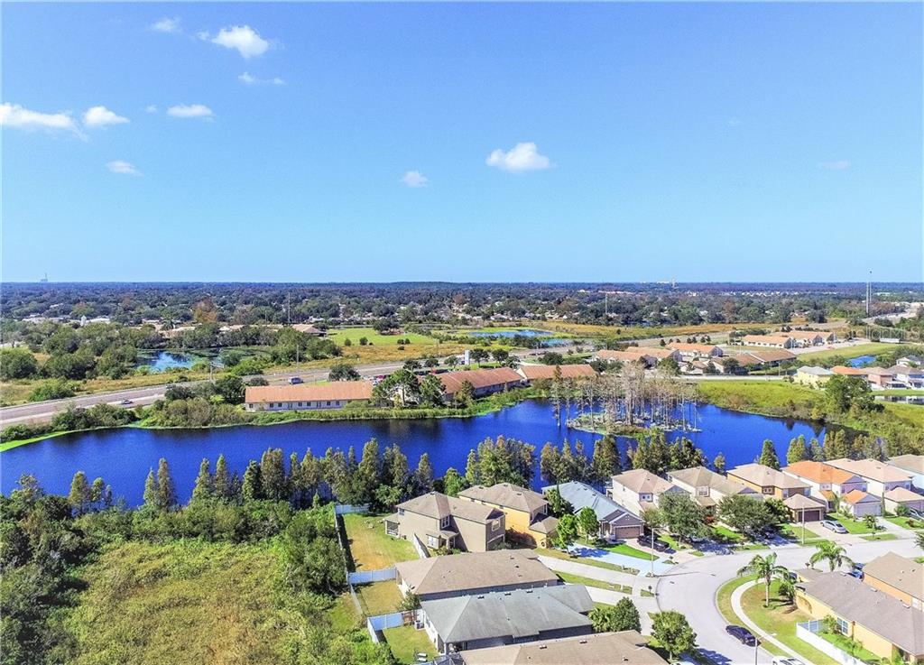 3430 Hunting Creek Loop New Port Richey, FL 34655 - Photo 1 of 1 an aerial view of a city with lots of residential buildings and ocean view