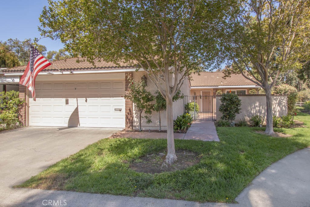 3399 Punta Alta, Unit B Laguna Woods, CA 92637 - Photo 1 of 1 a front view of a house with garden