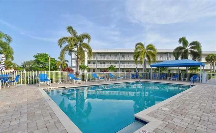 9880 Marina Boulevard, Unit 1516 Boca Raton, FL 33428 - Photo 29 of 32 a view of a swimming pool with a lounge chair