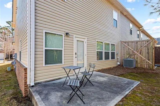 a view of a house with backyard and sitting area