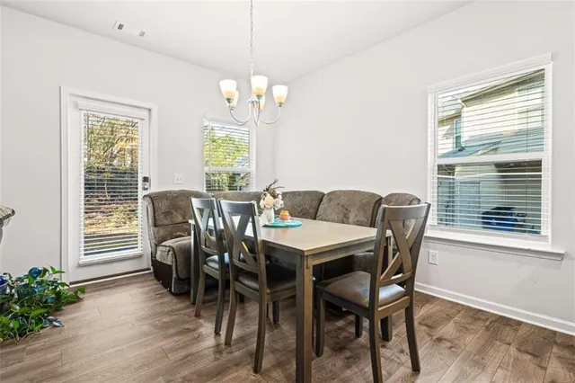 a view of a dining room with furniture window and wooden floor
