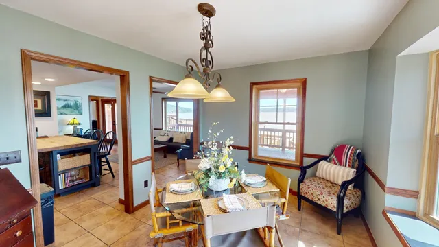 a living room with furniture chandelier and a window