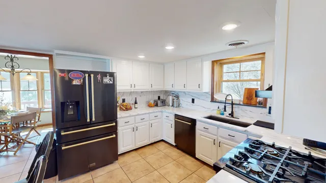 a kitchen that has a sink stainless steel appliances and cabinets