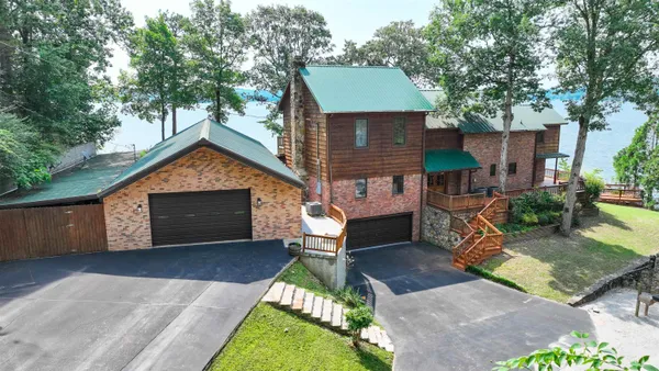 a front view of a house with a yard and outdoor seating