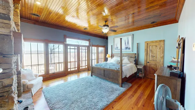 a spacious bedroom with a balcony a bed and a couch