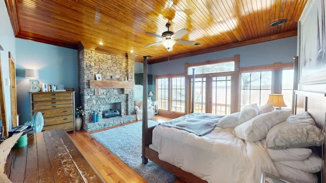 a large bedroom with a bed and large windows