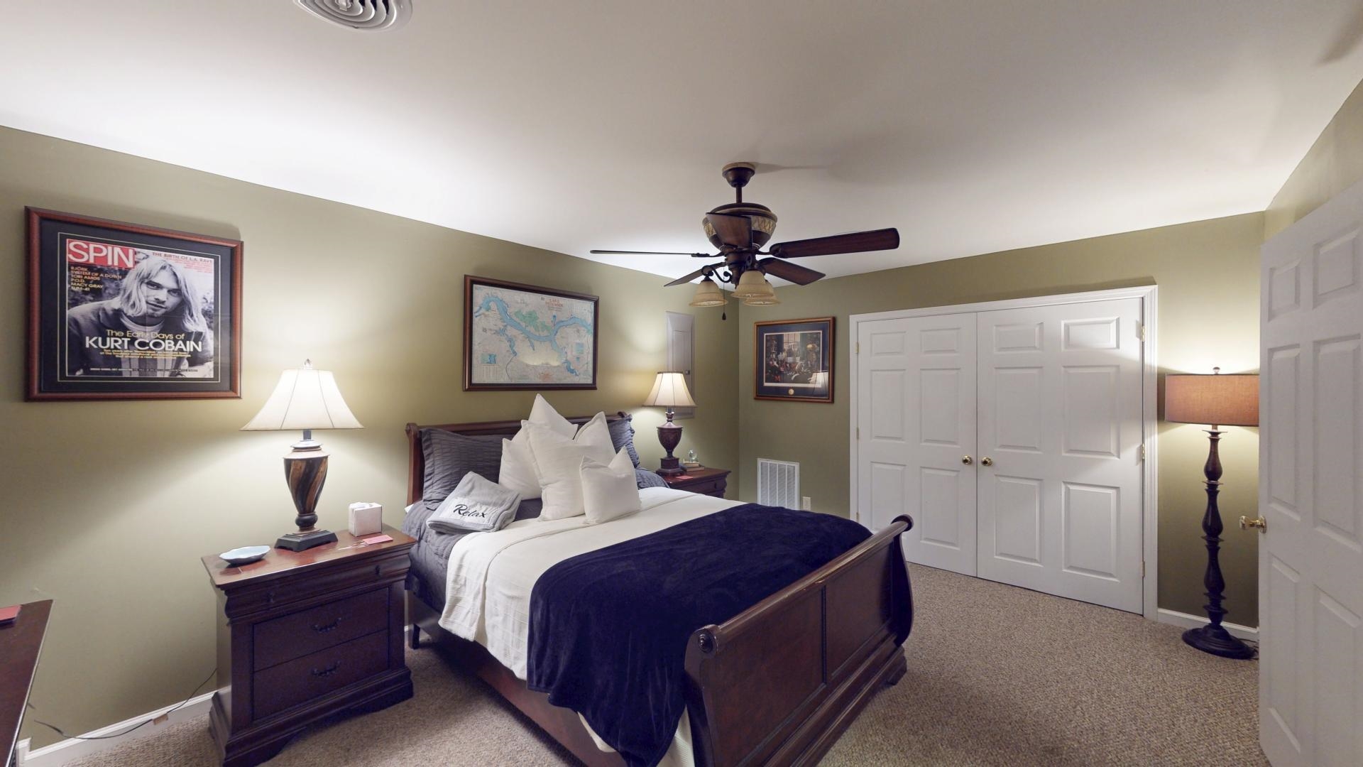 19 Beach Drive Iuka, MS 38852 - Photo 30 of 40 a bedroom with a large bed and a chandelier