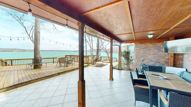 an outdoor sitting area with couch and wooden floor