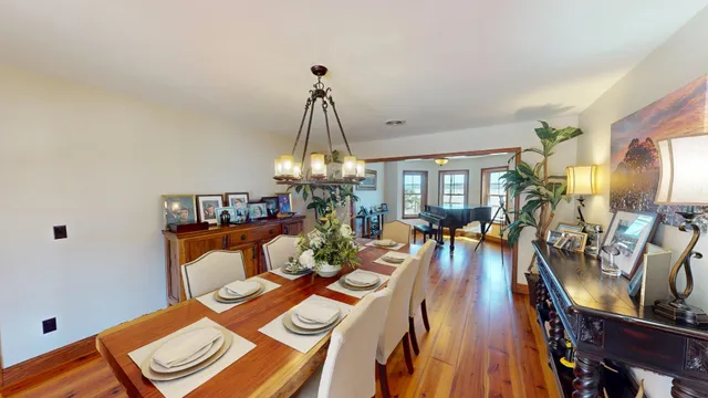 a view of a dining room with furniture and chandelier