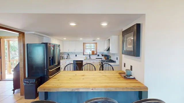 a view of a dining room with furniture and a window